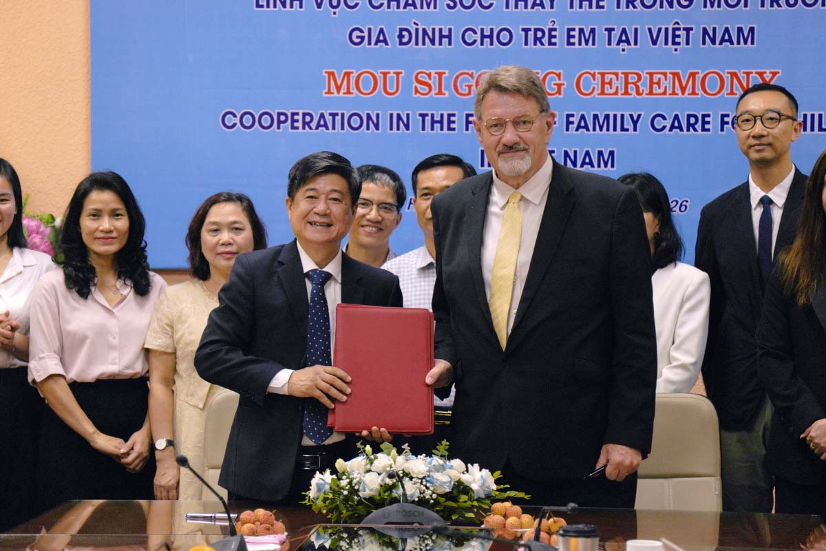 Care for Children Founder Robert Glover signs an agreement with the government in Viet Nam